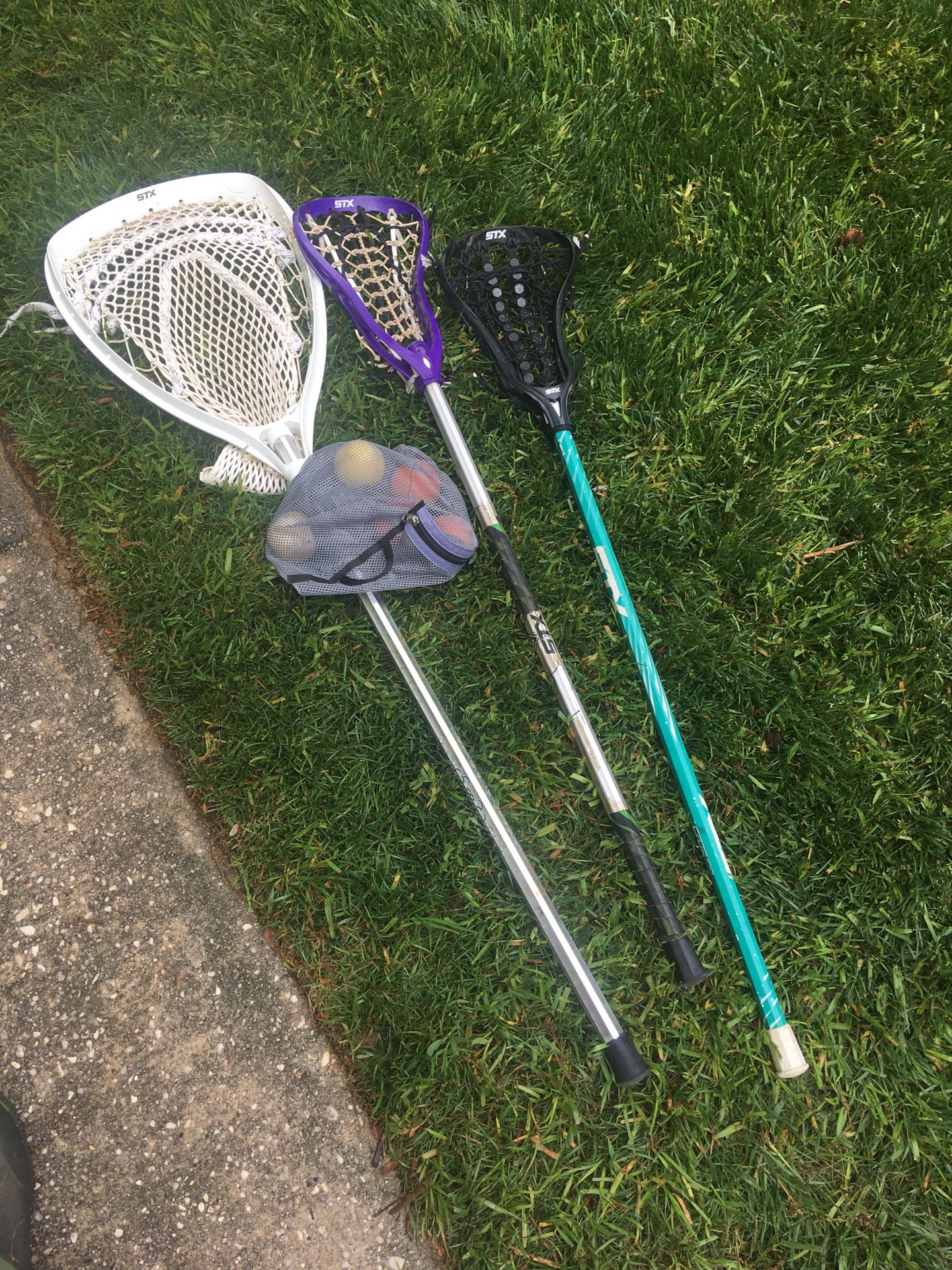 Girls lacrosse goalie stick, tennis racket and Kidd’s golf clubs, purple & black sticks sold