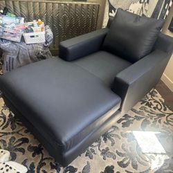 Special order custom  modern soft black leather chaise lounge with recessed arms and two plush throw cushions … stainless steel leg. 63 “ long   34” w