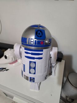 Interactive R2-D2 robot is made of durable plastic with blue and silver accents. This droid has light-up features and multiple sensors for movement. I