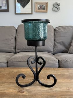 Candle glass and iron holder.