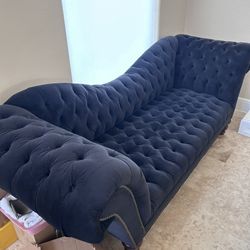 Upholstered Black Tufted Sofa And Ottoman