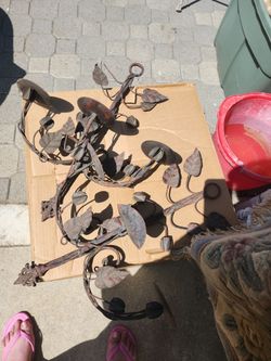 Material and Style: Crafted from dark, hand-forged iron with a reddish-brown patina.