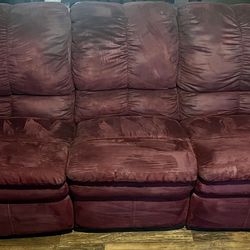 maroon sofa with recliners on each end