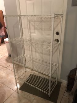 White metal shelf, 4 shelves, 54”T x 35 1/2”W x 14”D