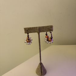 Handmade bohemian-style hoop earrings in metal with white and coral beads in a vintage style