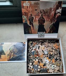 Two, 500 piece Star Wars Puzzle, one is foil pieces.  Put together one