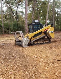 Skid steer with mulcher head
