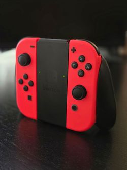 NINTENDO SWITCH NEON RED OEM  JOYCONS  WITH JOYCON GRIP