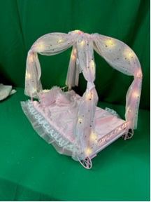 New.  Firm, Badger Basket Royal Carriage Metal Doll Bed with Canopy, Bedding and LED Lights - Pink/White/Stars
