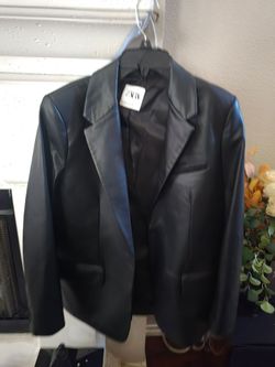 Structured faux leather blazer by Zara. Notched lapel and single-breasted front. Front flap pockets and chest welt pocket. Smooth, sleek finish for mo