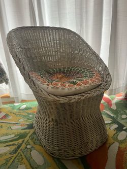 White wicker chair with coushion