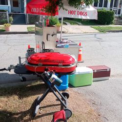 Hot cart with two burners, umbrella, and utensils pans the grill two grills and a ice cream cart with the wheels and brackets for umbrell 