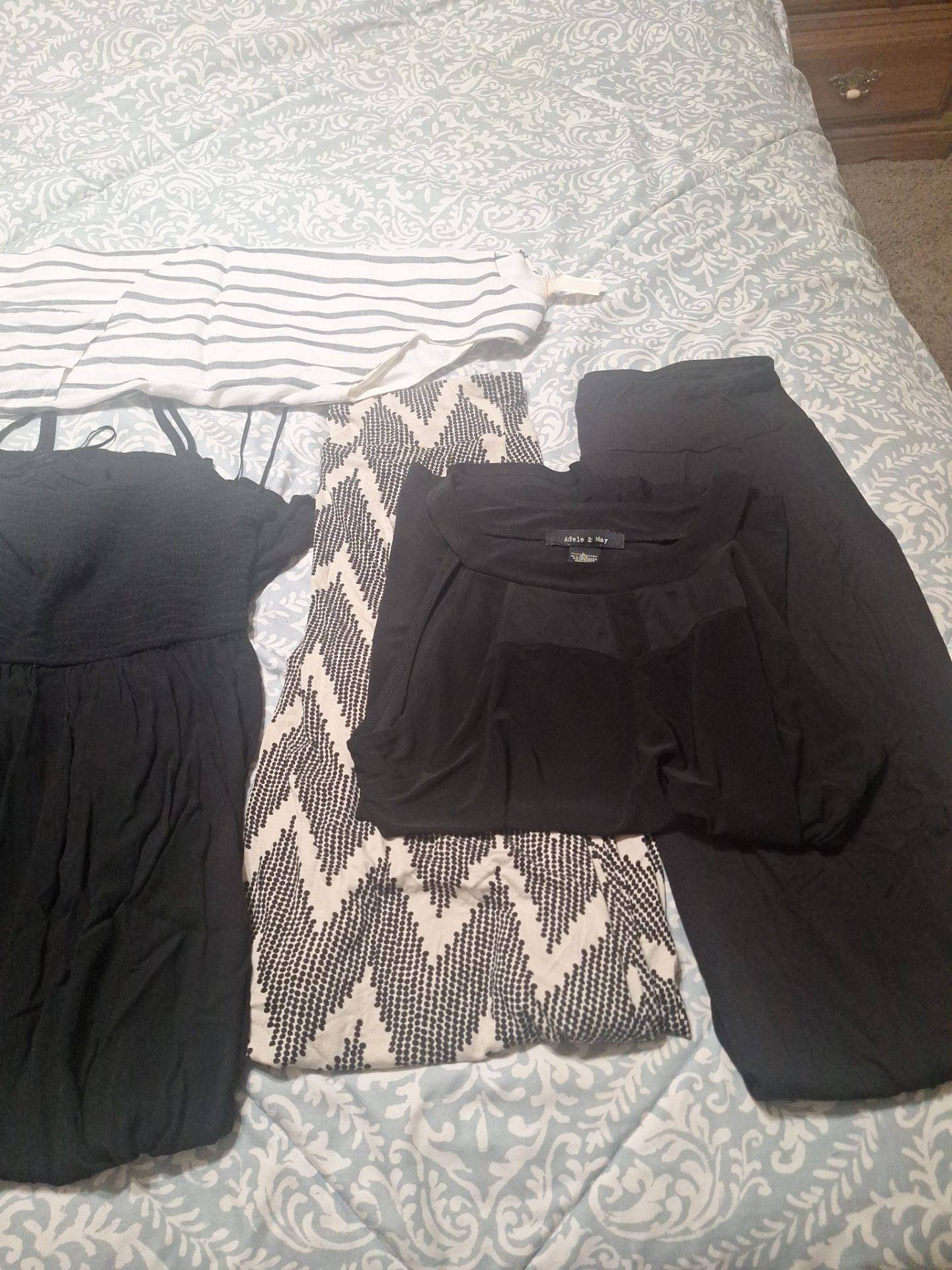 3 large dresses. 2 size Medium skirts 1 large black top 1 large white and Grey dress linned and 1 jumper large. All seven pieces for 7 dollars.