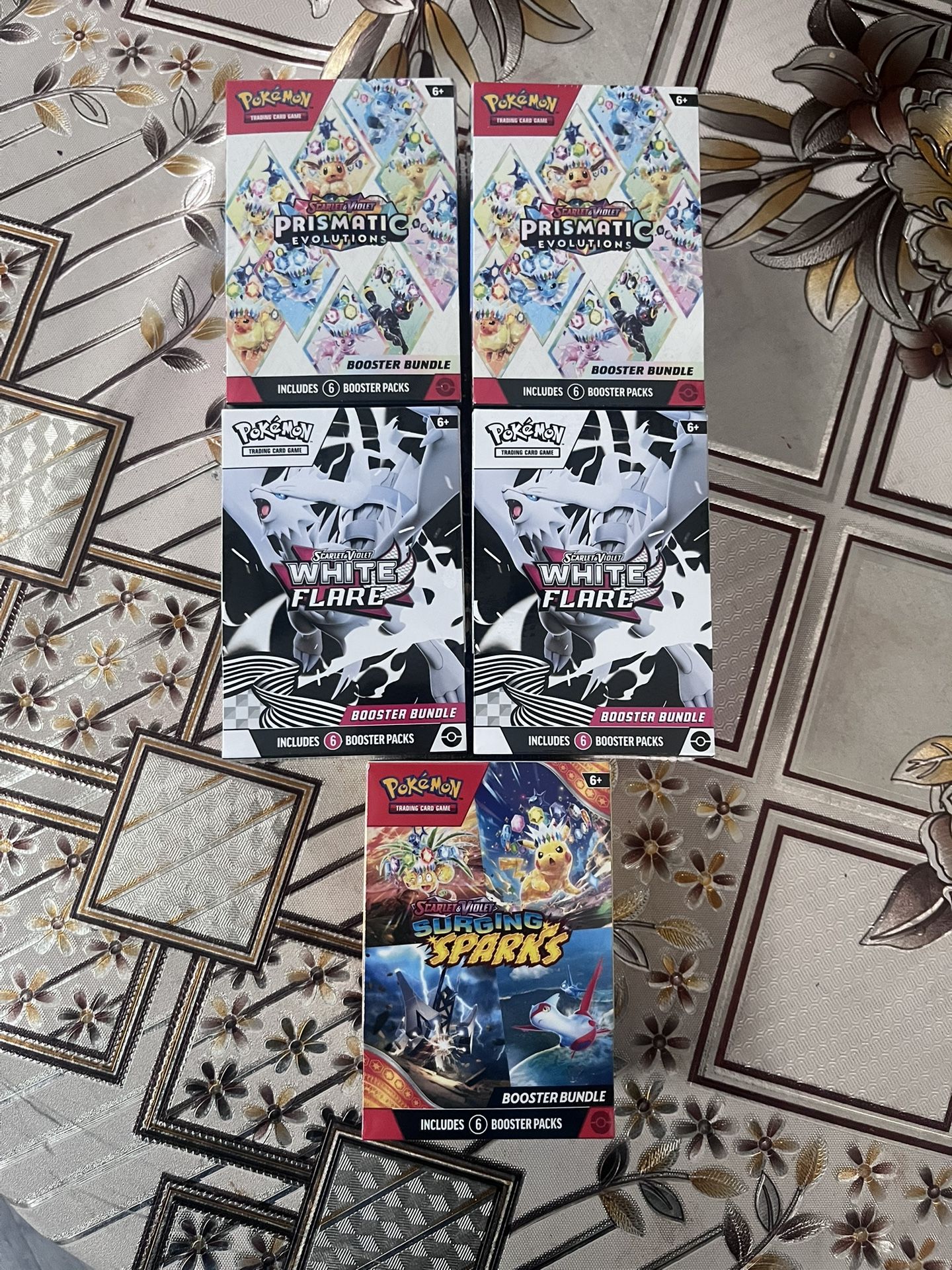 Surging Sparks, White Flair, And Prismatic Evolutions Booster Bundles