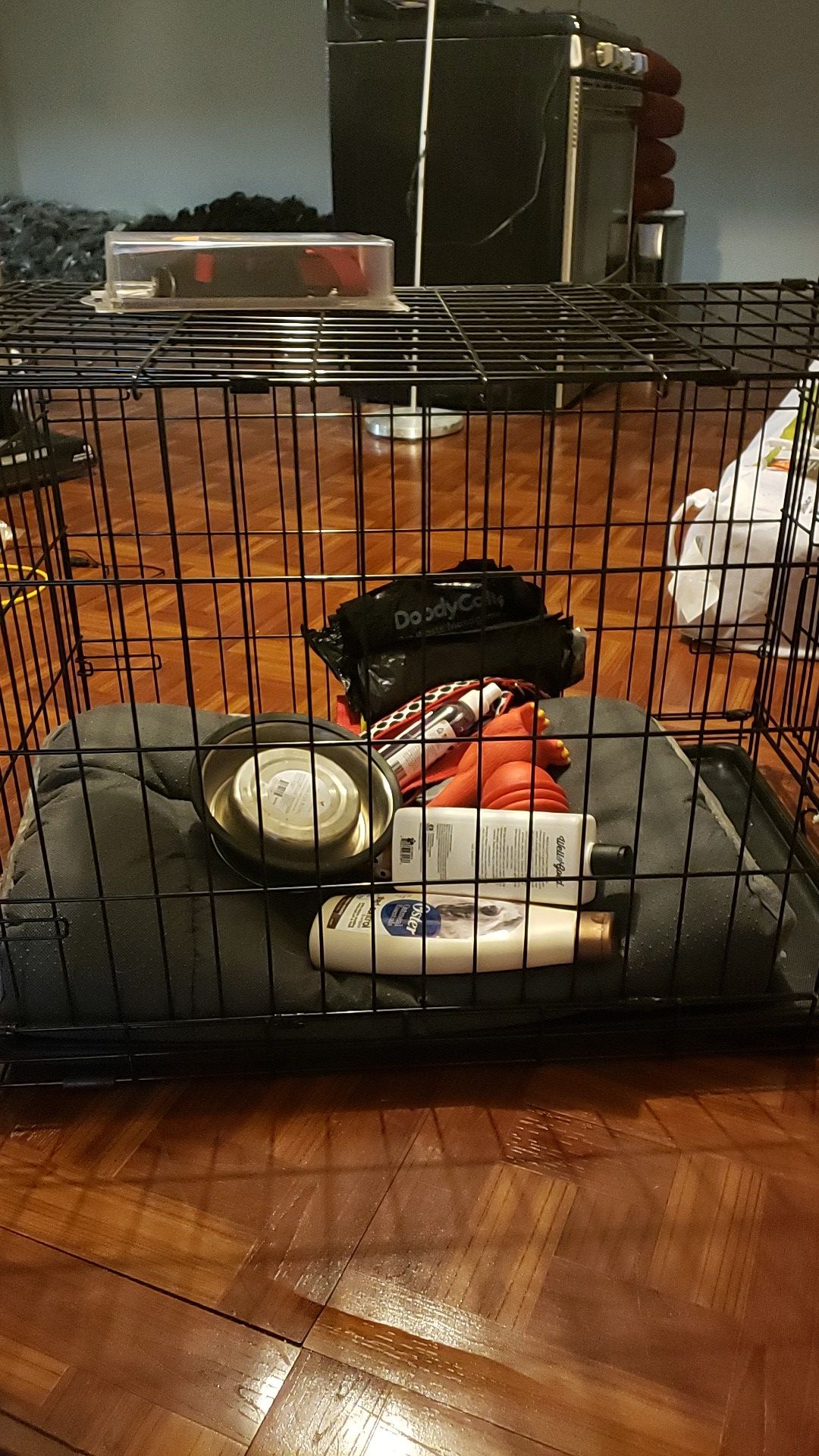 Medium sized dog kennel with dog stuff inside