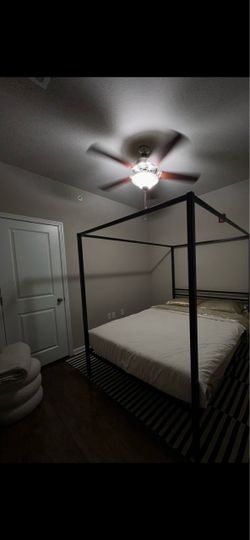 Black Metal Four-Poster Bed Frame + Mattress