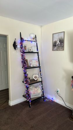 Ladder wall leaning shelf.