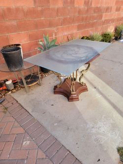 A glass table with vintage base