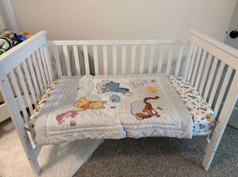 White Wood Baby Crib with Winnie the Pooh Bedding