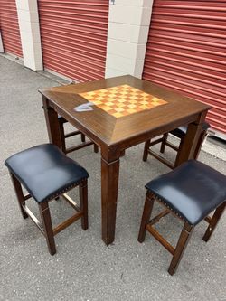 Square wooden high table and four chairs