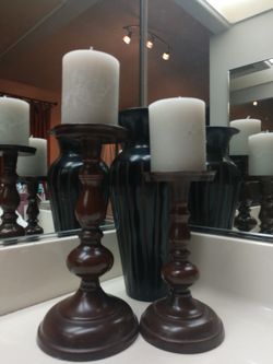 Metal candle holders with candles.