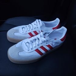 Adidas Samba shoes in cloud white with scarlet (red) stripes and a gum sole. 