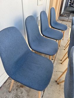 Set of 4 mid-century modern style dining chairs with blue fabric upholstery