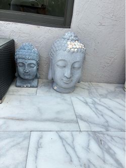 Two buddha heads statues