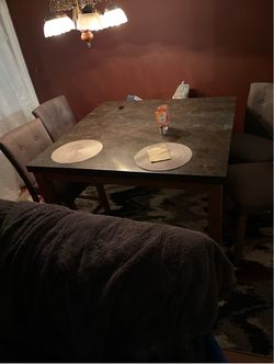 Marble top dining table with chairs and ottoman