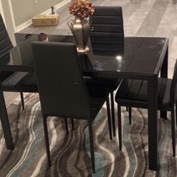 A Beautiful Glass Dinning Table With A Set Of 4 Chairs  For Sell.