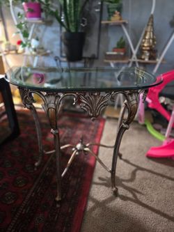 Ornate glass top metal half-moon console table