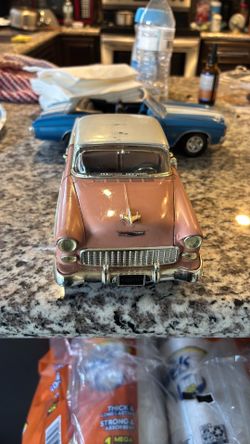 1:18 scale die-cast model  1955 Chevrolet Bel Air hardtop in a two-tone pink and white finish.