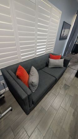 Grey fabric couch from living space and cushions