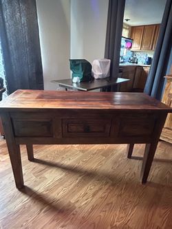 A solid wood sofa table 48”W 18”D 30”H