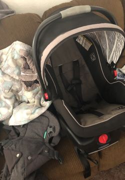 Car seat with base, shopping cart cover and baby carrier (carrier brand new). ALL for $45