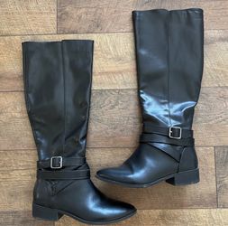 Black knee high boots with buckle detail