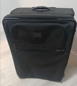 TUMI Luxury LUGGAGE.  Rolling suitcase.  Black. Waterproof. 24" height x 16" width x 12" depth  (not a carry-on) Excellent Condition, Like new!!!
