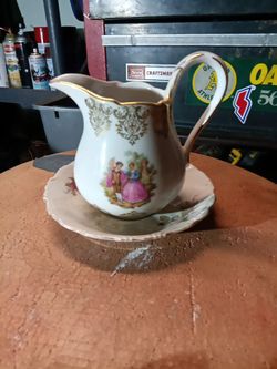 Creamer and saucer set with gold trim
