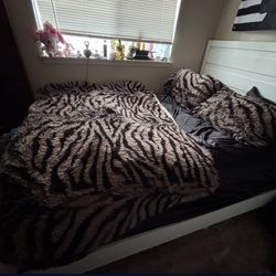 Queen bed with mattress and large white dresser with one night stand
