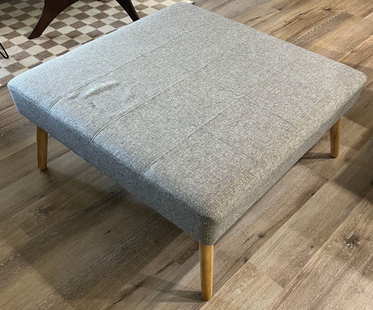 Square grey ottoman/coffee table with wood legs