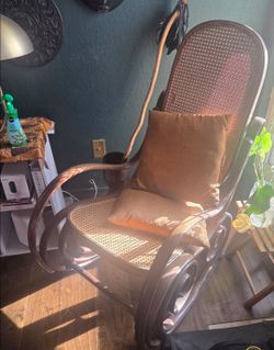 vintage bentwood rocking chair features a distinctive caned back and seat