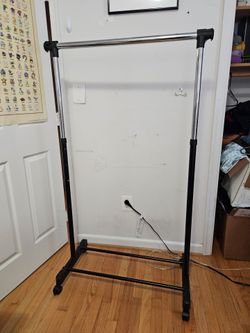 Black Plastic/Metal 64x33x16" Adjustable Height Clothing Rack with Wheels