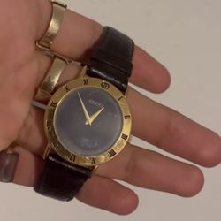 Gucci 3000M  watch, a black dial, and a leather strap.