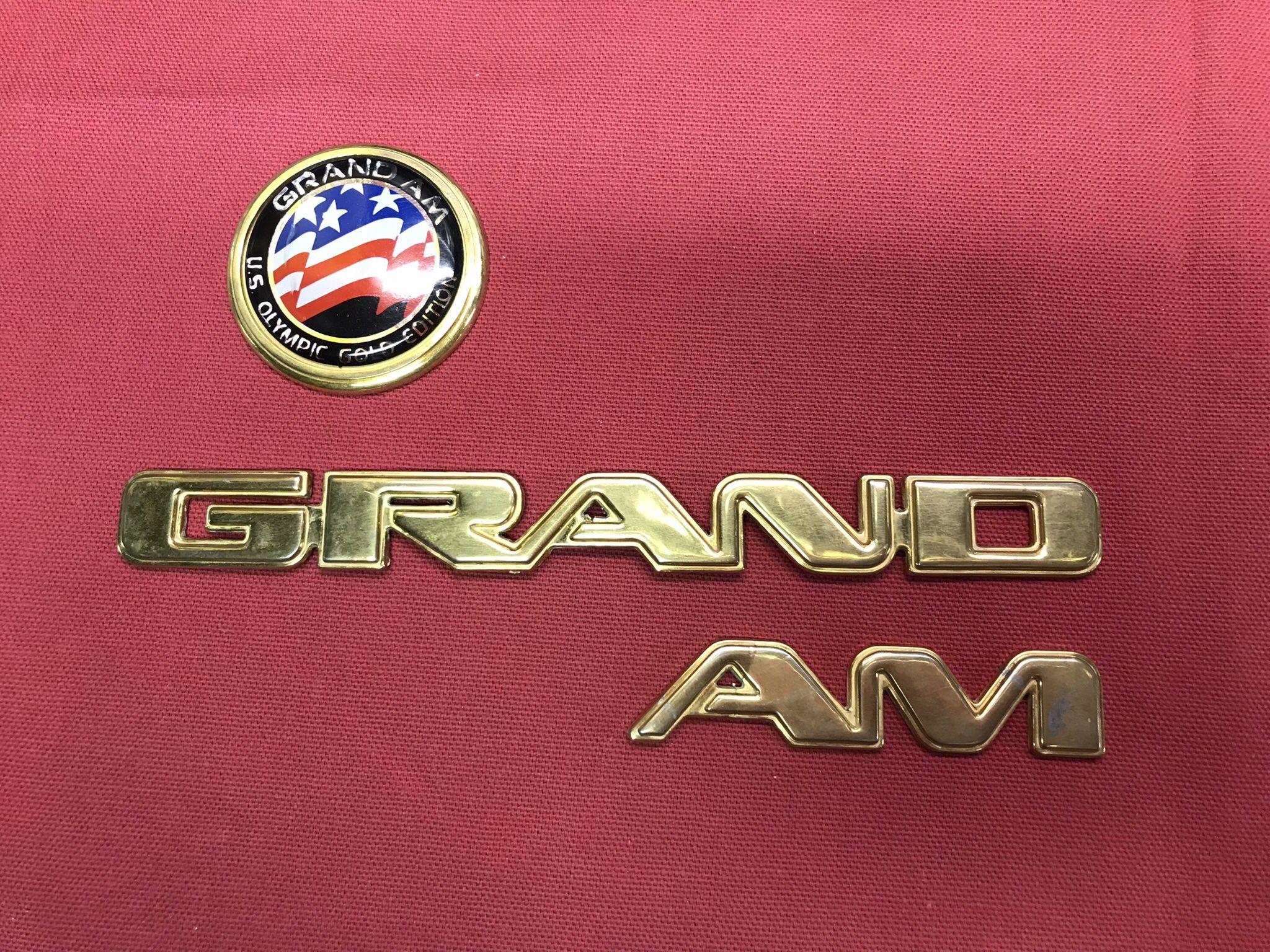 Grand AM Badges gold Olympic Edition. 