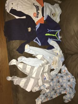 Collection of boys size 9 month baby onesies shirts and sleeper pajamas