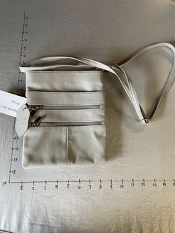 light gray or off-white crossbody bag with a multi-pocket design
