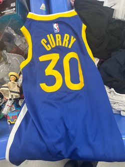 blue Golden State Warriors basketball jersey with yellow trim, featuring Stephen Curry's name and number 30 on the back