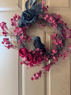 Elegant red floral wreath with a decorative black bird accent