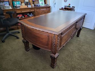 Desk  carved, all drawers worked fine in the front. You have 2 slideouts that you could actually sit there and work at that side. Also carved wood, pe