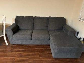 Gray sofa and table with 5 chairs